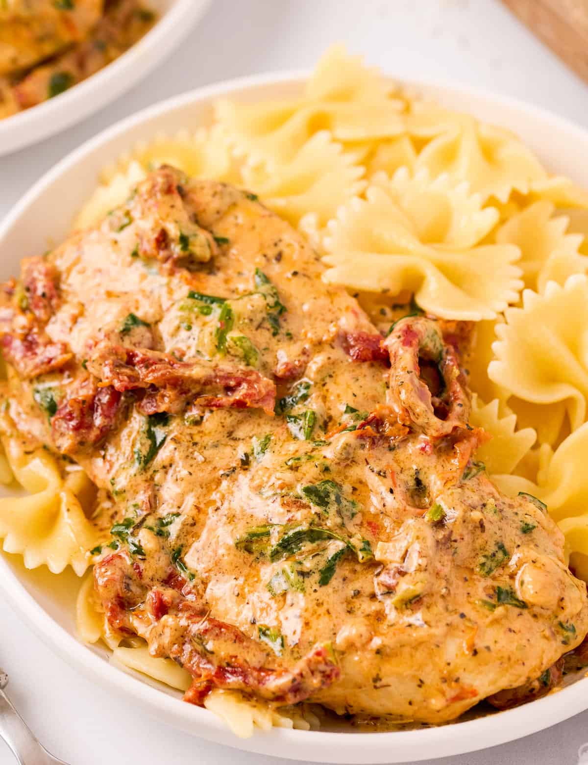 This One Pan Tuscan Chicken is a quick and easy one-pot meal that's sure to be a family favorite!  Juicy chicken, a creamy sauce made with bursts of sun dried tomatoes, Parmesan cheese and spinach, and it's all ready in about 30 minutes, making it a great weeknight dinner option.