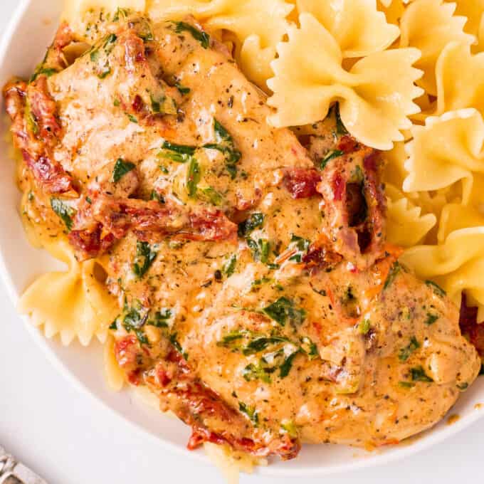 tuscan chicken in a bowl with farfalle pasta