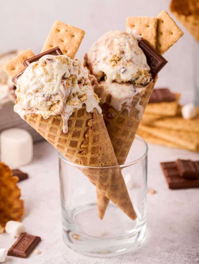 two waffle ice cream cones with scoops of smores no churn ice cream in them