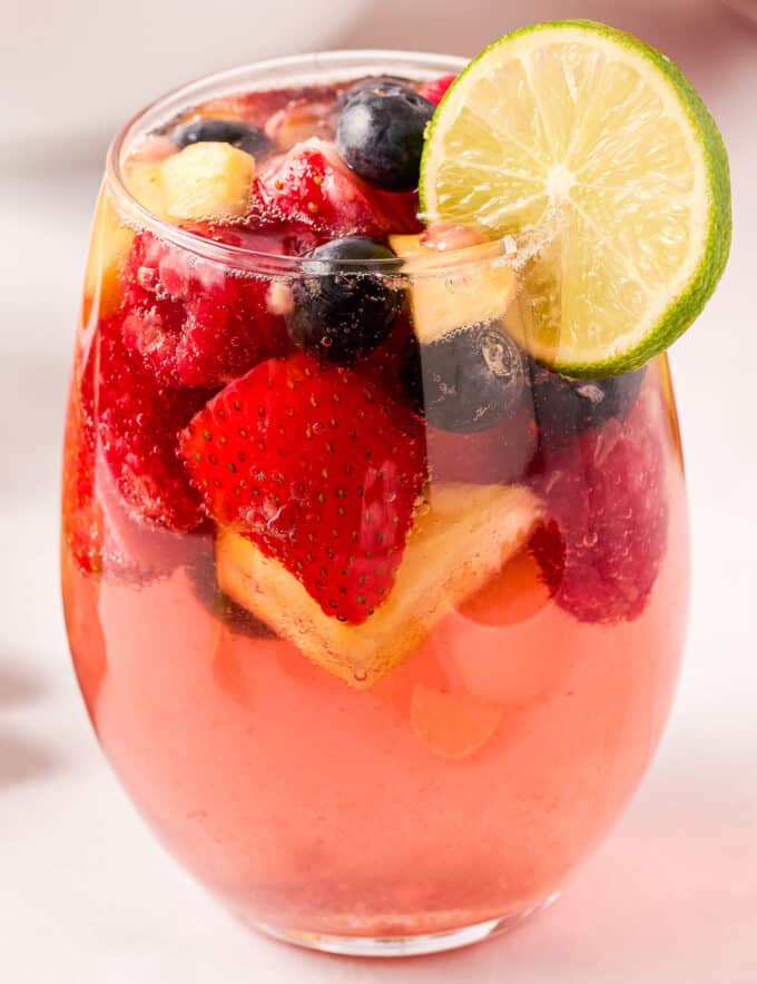 This light and sweet twist on a classic sangria recipe uses sweet moscato wines, raspberry liqueur, plenty of fruit, and made bubbly with lemon lime soda and seltzer water! Great to make ahead and loved by all!