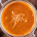 overhead view of caramel sauce with salt in glass jar