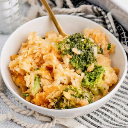 bowl of cheesy broccoli rice casserole with fork in it