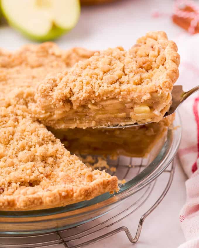 serving a slice of apple pie with crumble topping