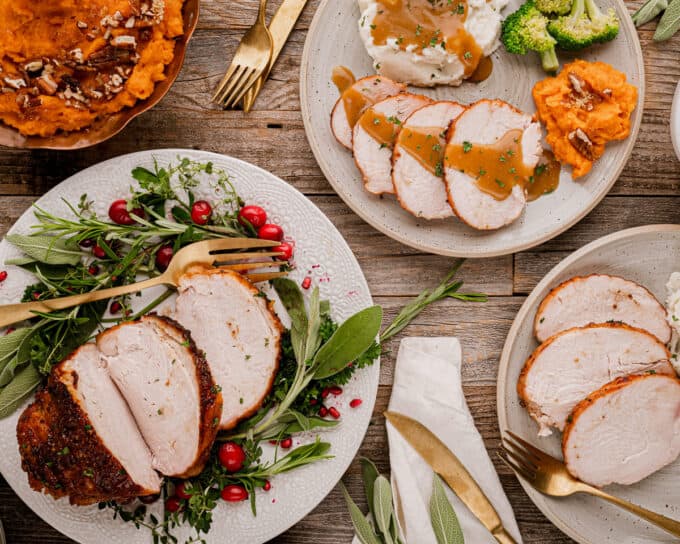 holiday table with sliced turkey breast and sides