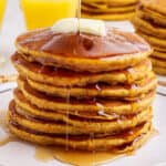 stack of pumpkin pancakes with maple syrup