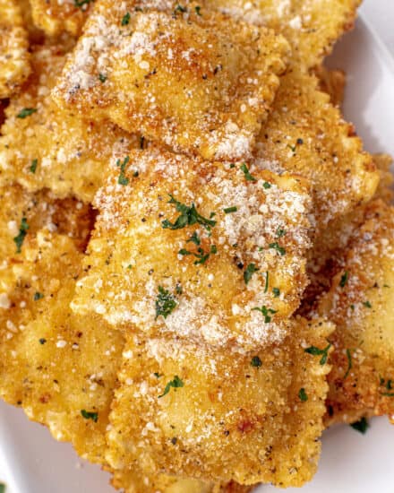 This Fried Ravioli recipe is made with frozen ravioli (meat, cheese, or veggie) that are coated in Italian panko breadcrumbs and fried until perfectly crispy and golden brown. Dust them with Parmesan cheese and serve alongside some marinara sauce and watch them disappear! Perfect as an appetizer, game day food, or a fun family dinner!