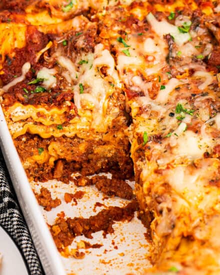 This classic lasagna recipe has layer upon layer of meaty and cheesy deliciousness! Perfect as a freezer meal or a big family dinner, this lasagna is made easy with no-boil noodles, a rich bolognese-style sauce, herbed ricotta cheese, and plenty of mozzarella and Parmesan!