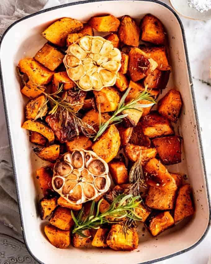 overhead view of baking dish filled with roasted sweet potatoes and garlic