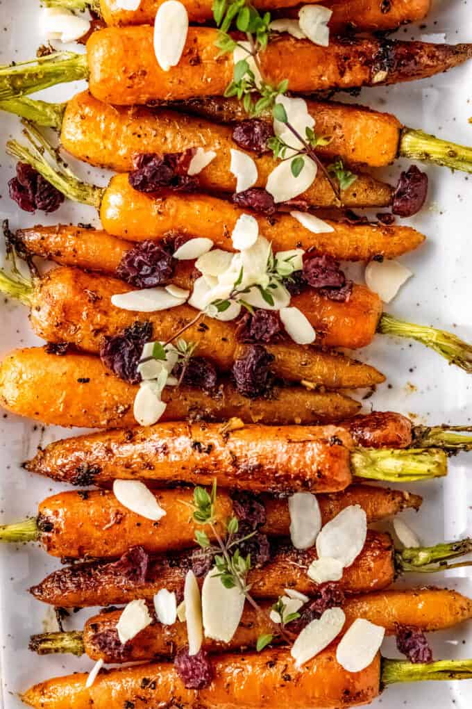 line of roasted carrots on white platter