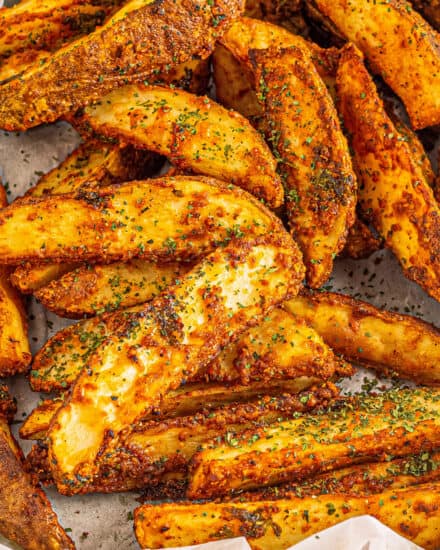 These Baked Potato Wedges are seasoned with zesty blend of spices and baked until gloriously crispy on the outside, and soft and fluffy inside! They're the perfect side dish!
