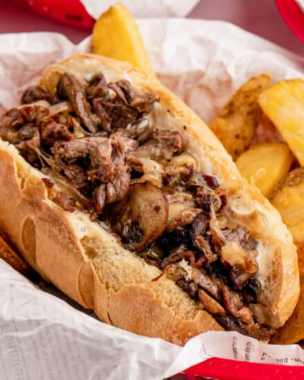 These cheesesteaks are made with juicy chopped strips of ribeye, caramelized onions, golden brown mushrooms, and are smothered in gooey provolone cheese. All that goodness is wrapped up in a tender hoagie roll that's been slathered in a creamy garlic horseradish sauce!