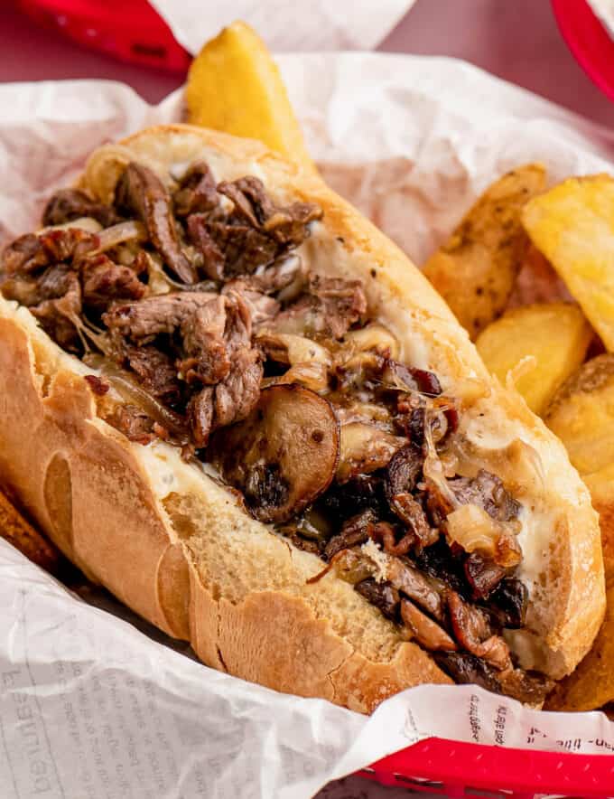 These cheesesteaks are made with juicy chopped strips of ribeye, caramelized onions, golden brown mushrooms, and are smothered in gooey provolone cheese. All that goodness is wrapped up in a tender hoagie roll that's been slathered in a creamy garlic horseradish sauce!