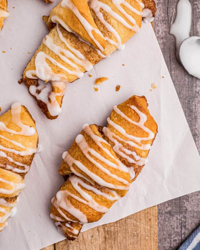 overhead view of crescent rolls with cinnamon on parchment paper