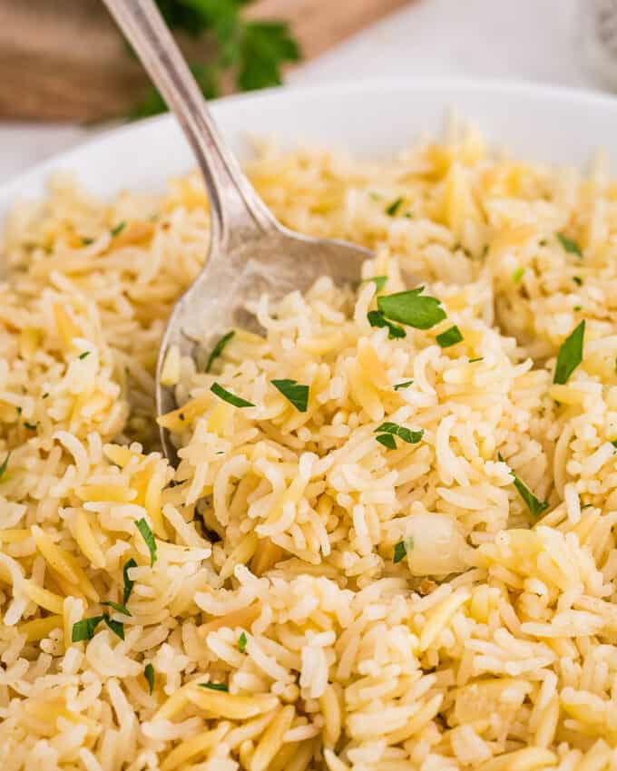 bowl of rice pilaf with a serving spoon in it