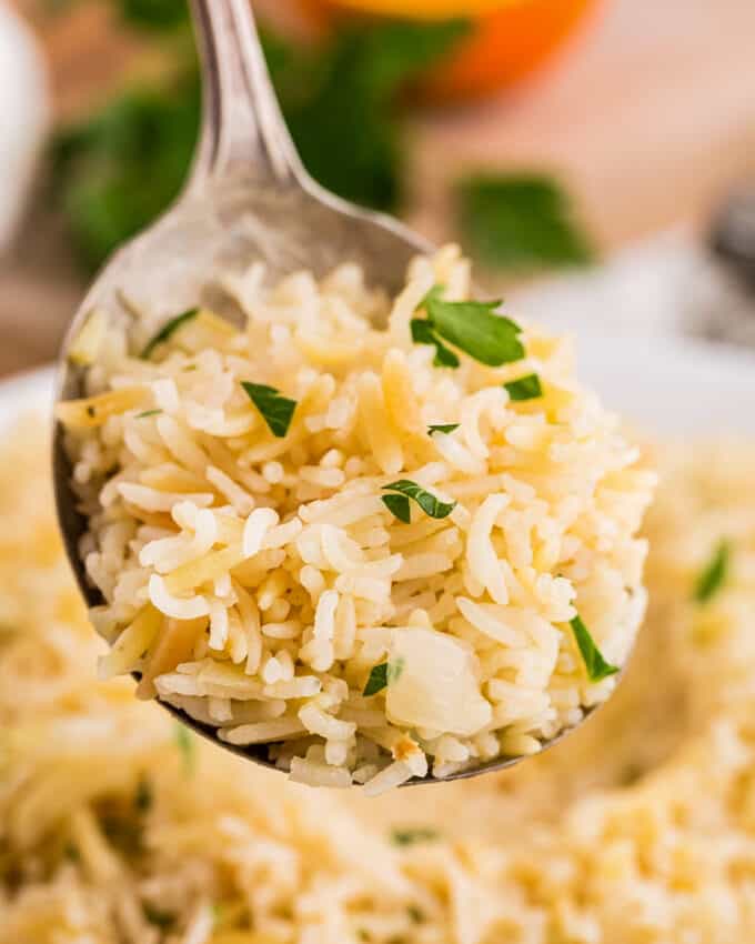 close view of a serving spoon of rice pilaf