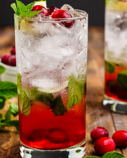 These tart and sweet cranberry mojitos are a festive twist on a classic cocktail, and are perfect for all your winter holiday gatherings! This recipe includes both small and large batch instructions.