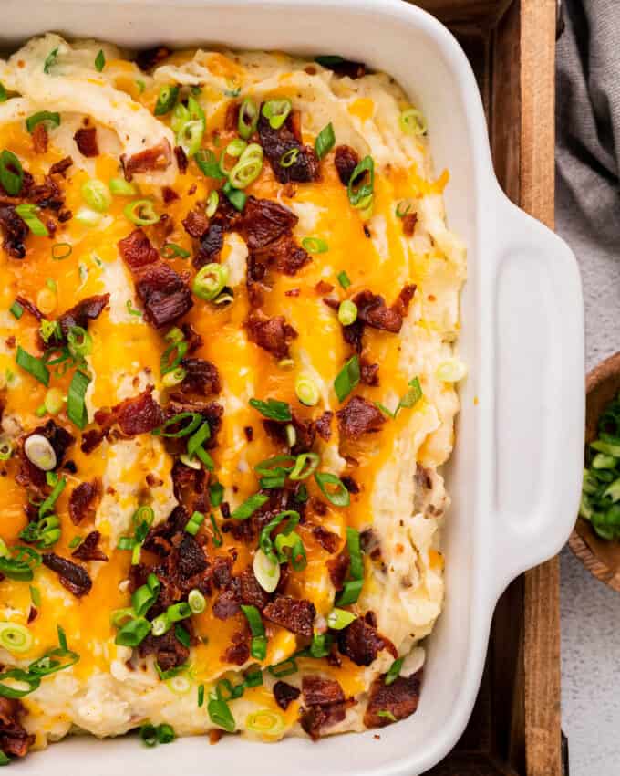loaded mashed potato casserole in white baking dish