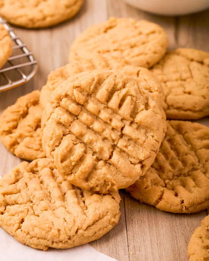 soft peanut butter cookies on a table next to a cooling rack