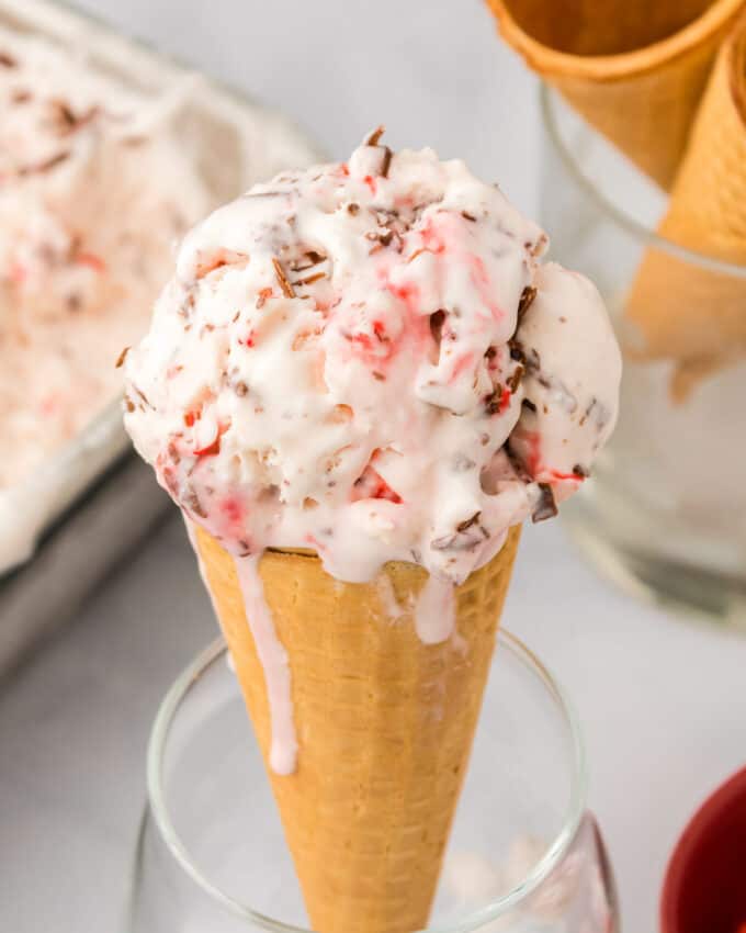 waffle cone filled with a generous scoop of ice cream with peppermints and chocolate