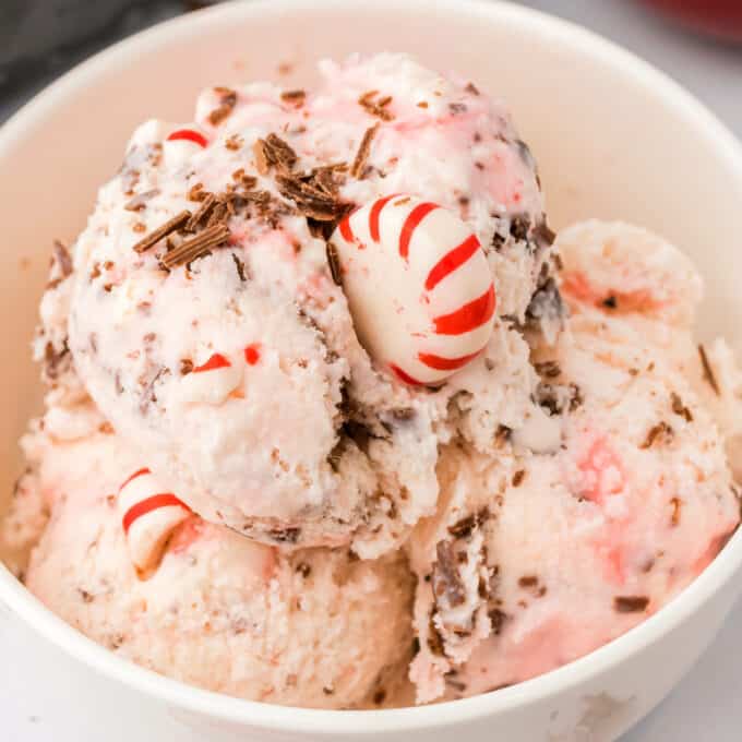 three scoops of peppermint ice cream in white bowl