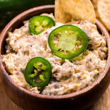 wooden bowl of jalapeño popper dip with tortilla chips