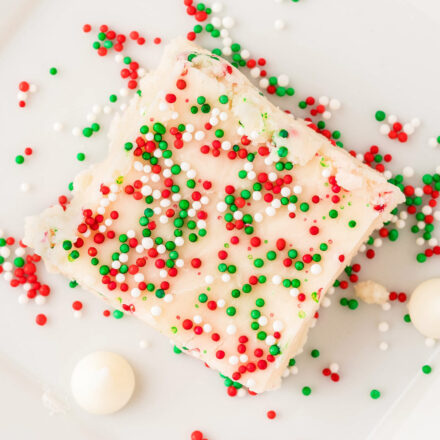 overhead view of a square piece of sugar cookie fudge with extra holiday sprinkles on top