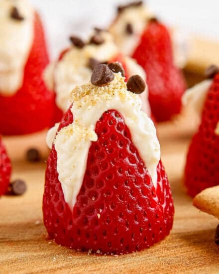 These fresh strawberries are filled with an easy 4 ingredient no-bake cheesecake filling, then sprinkled with graham cracker crumbs and mini chocolate chips! They're the perfect simple dessert to bring to a party or serve after dinner.