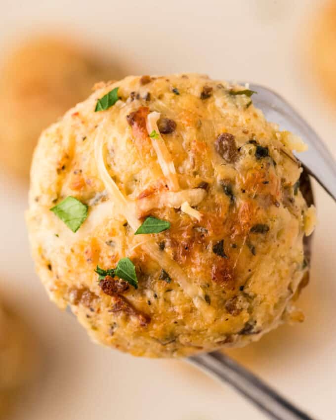 holding a cream cheese stuffed mushroom