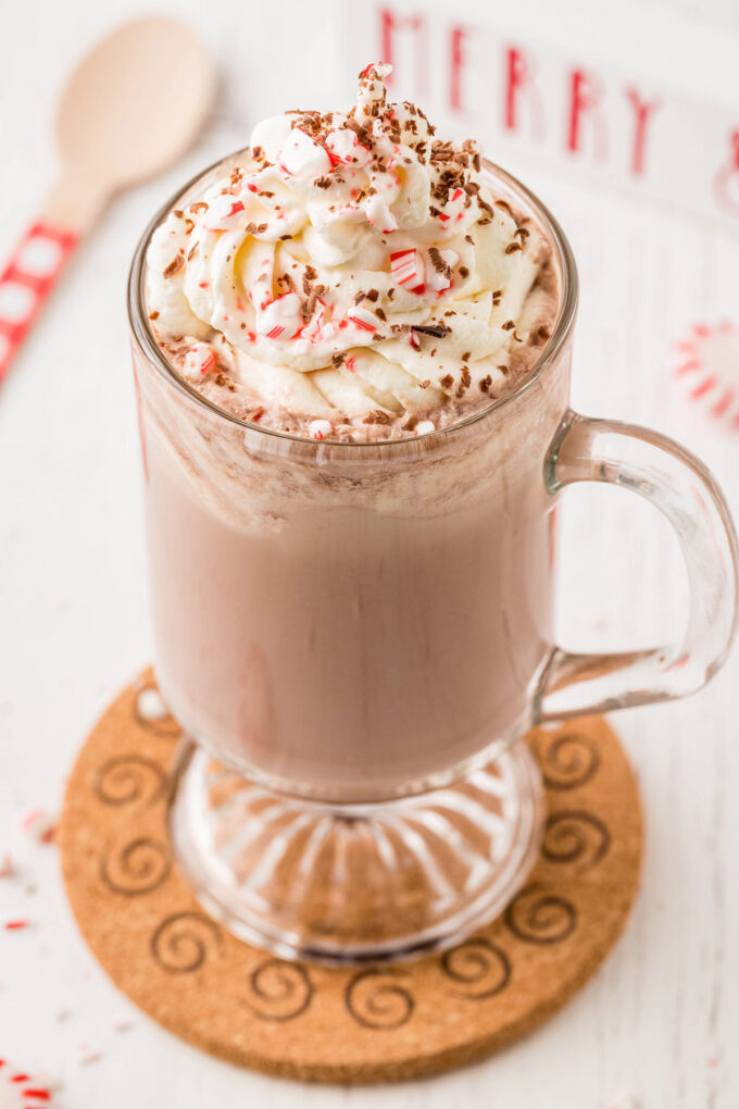 glass mug of peppermint mocha with plenty of whipped cream