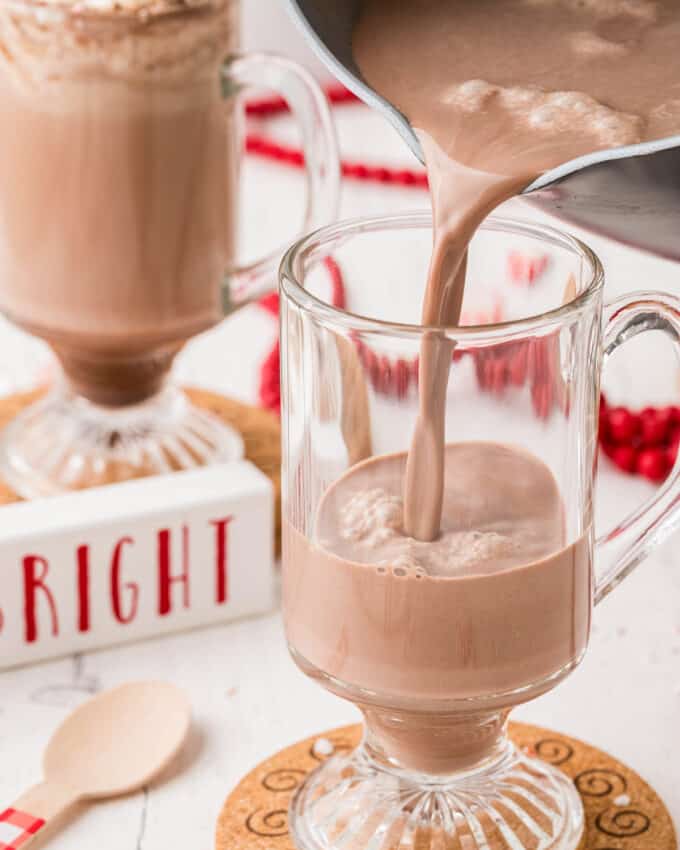 pouring peppermint mocha into a glass mug