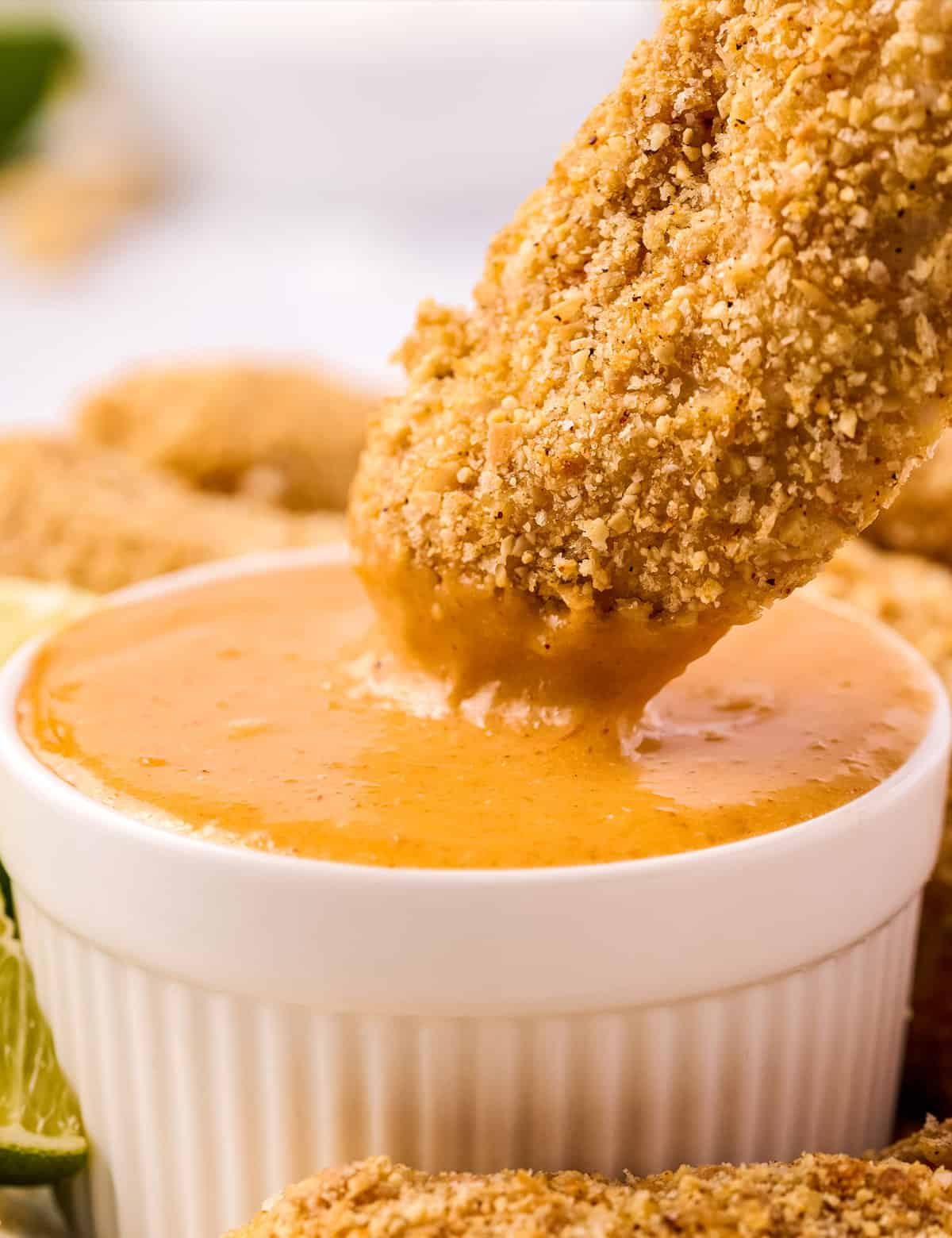 These chicken tenders are coated in an incredible cashew/coconut crust, and dipped in a simple, yet oh so delicious, fiery mango dipping sauce. Baked instead of fried, this easy chicken recipe is perfect for a weeknight meal!