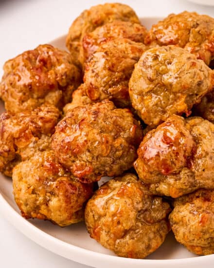 These savory cheesy sausage balls are made with 6 simple ingredients (including spices), and come together quickly. They're the perfect party appetizer that can be made ahead of time and even frozen!