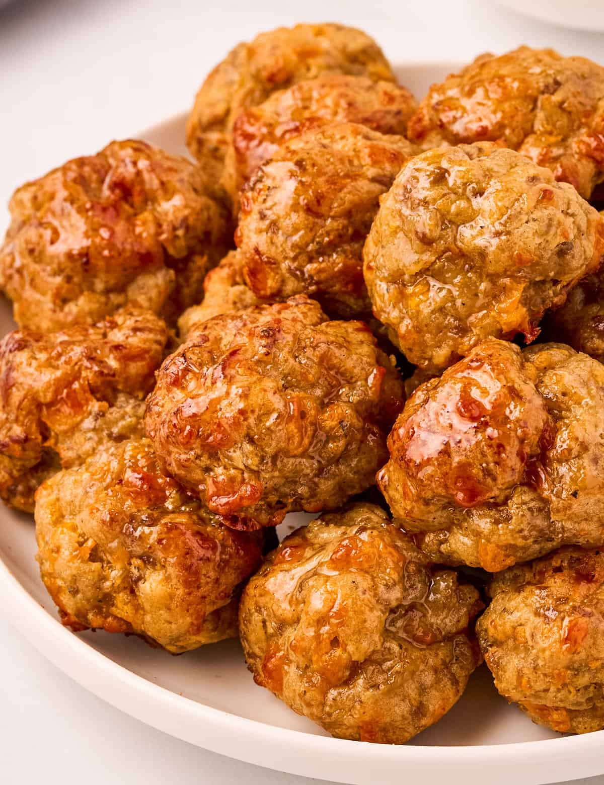 These savory cheesy sausage balls are made with 6 simple ingredients (including spices), and come together quickly. They're the perfect party appetizer that can be made ahead of time and even frozen!