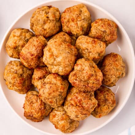 pile of sausage balls on a white round plate