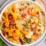 overhead view of creamy vegetable soup in white bowl