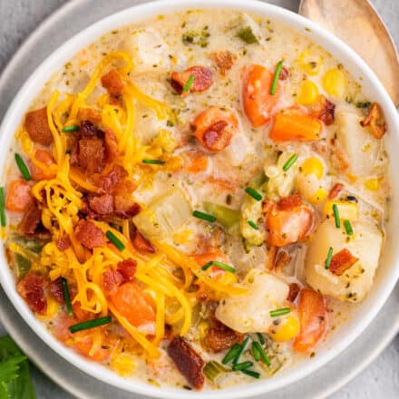 overhead view of creamy vegetable soup in white bowl