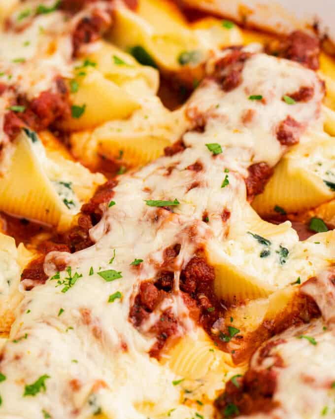 close up view of stuffed shells in baking dish