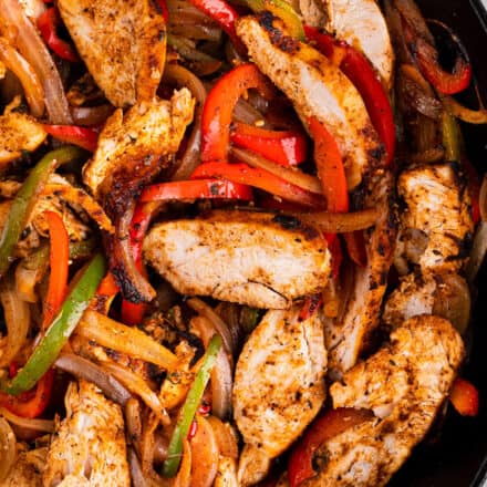 Juicy chicken, quickly marinated with a homemade fajita seasoning blend, seared and lightly charred with peppers and onions, all in the same skillet. Great in tacos, bowls, burritos, or just eaten with a fork. The perfect Tex-Mex weeknight dinner idea!