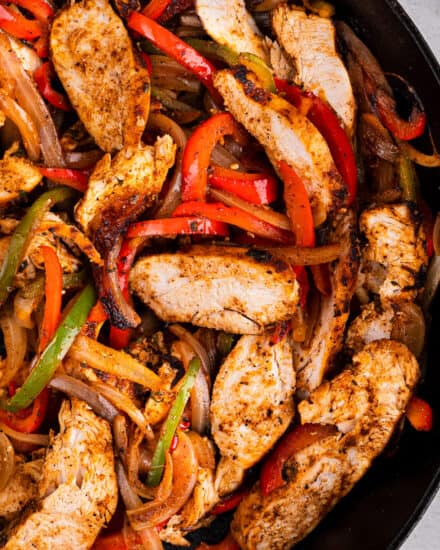 Juicy chicken, quickly marinated with a homemade fajita seasoning blend, seared and lightly charred with peppers and onions, all in the same skillet. Great in tacos, bowls, burritos, or just eaten with a fork. The perfect Tex-Mex weeknight dinner idea!