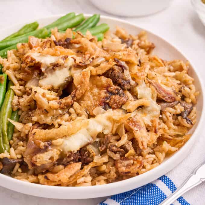 white plate with french onion baked rice and green beans