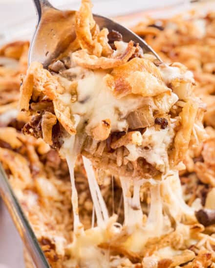Buttery, rich, and incredibly hearty, this baked rice casserole is made with french onion soup, beef broth, butter, onion, ground beef, fresh mushrooms, spices, gooey cheese, and topped with crunchy french fried onions! Perfect for a family dinner, this recipe can also be made partially ahead of time, and frozen!