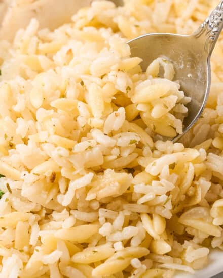 Simple yet full of flavor, this garlic parmesan rice pilaf is made with rice, tender orzo pasta, and plenty of garlic and cheese. It’s an easy side dish that’s perfect with just about any main dish, and tastes like a homemade version of Rice-a-Roni!