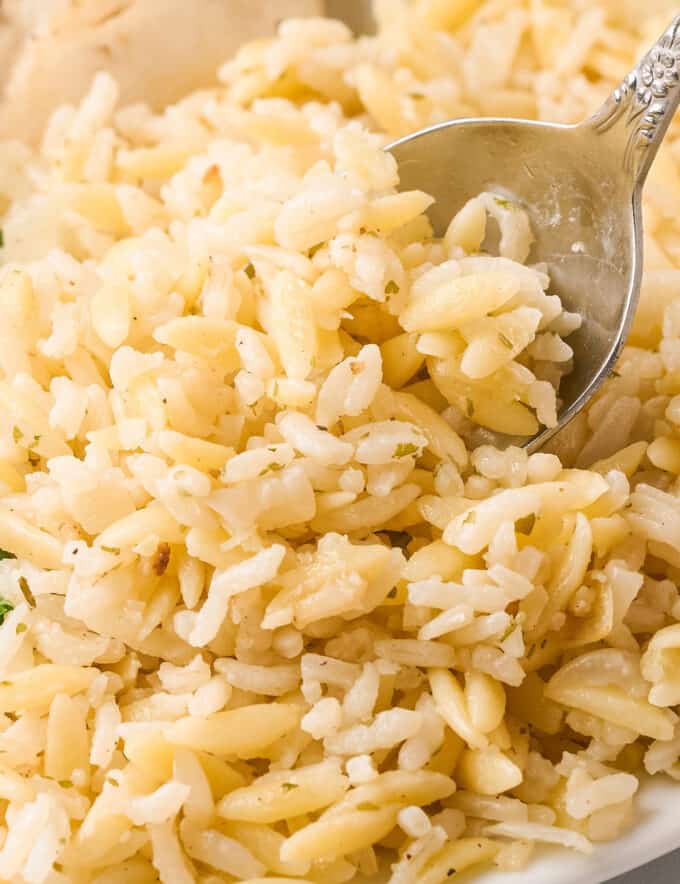 Simple yet full of flavor, this garlic parmesan rice pilaf is made with rice, tender orzo pasta, and plenty of garlic and cheese. It’s an easy side dish that’s perfect with just about any main dish, and tastes like a homemade version of Rice-a-Roni!
