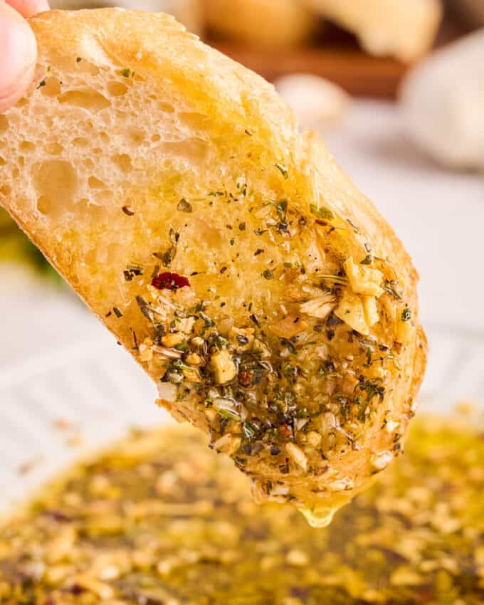 a slice of bread dipped in garlic and herb dipping oil