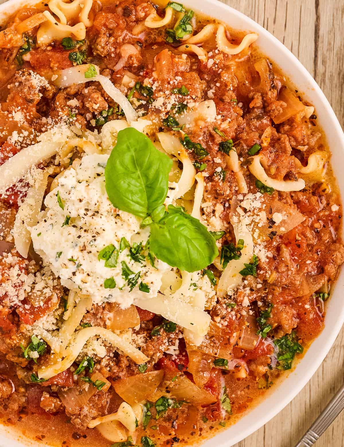 This Lasagna Soup has all the classic lasagna flavors, with none of the layering and extra work. This hearty and easy to make soup is ready quickly, so it's perfect for a busy weeknight dinner! Plus, stovetop, Instant Pot, and slow cooker directions!