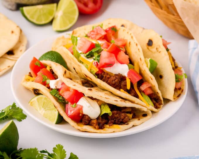 soft beef tacos made with homemade tortillas on white plate