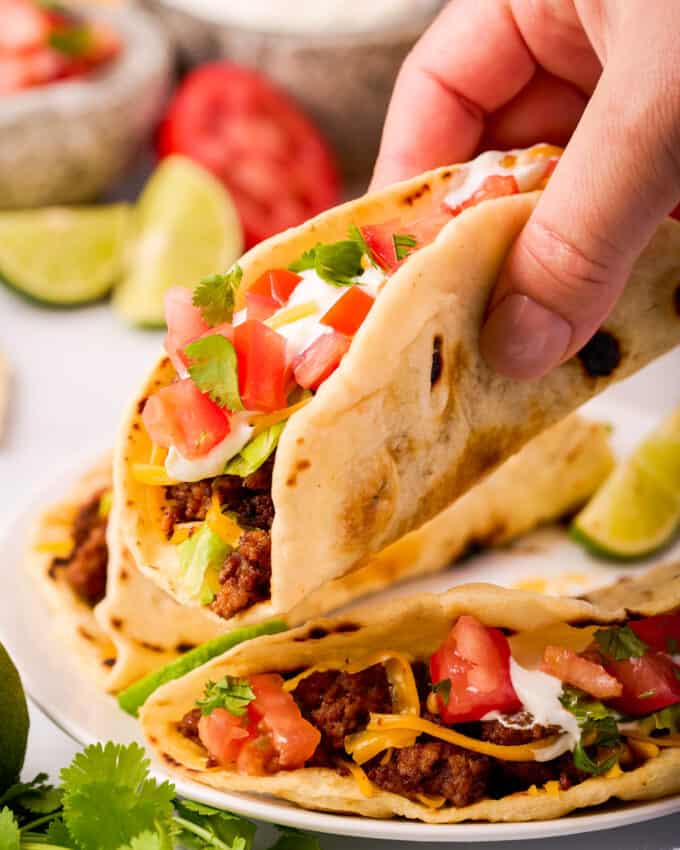 holding a soft taco made with homemade flour tortillas