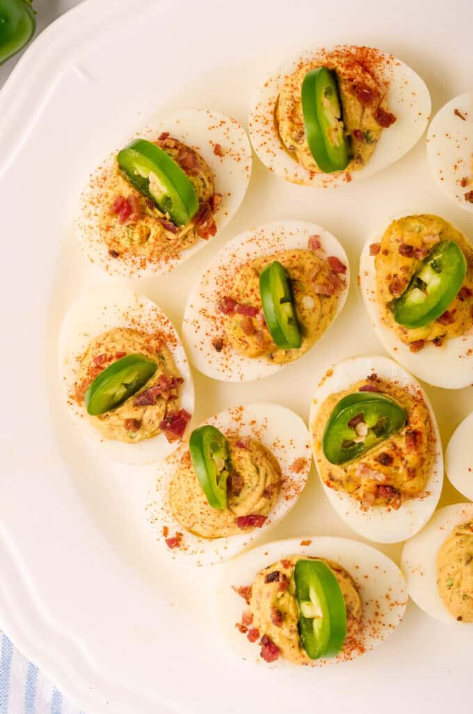 overhead photo of multiple deviled eggs on a white platter