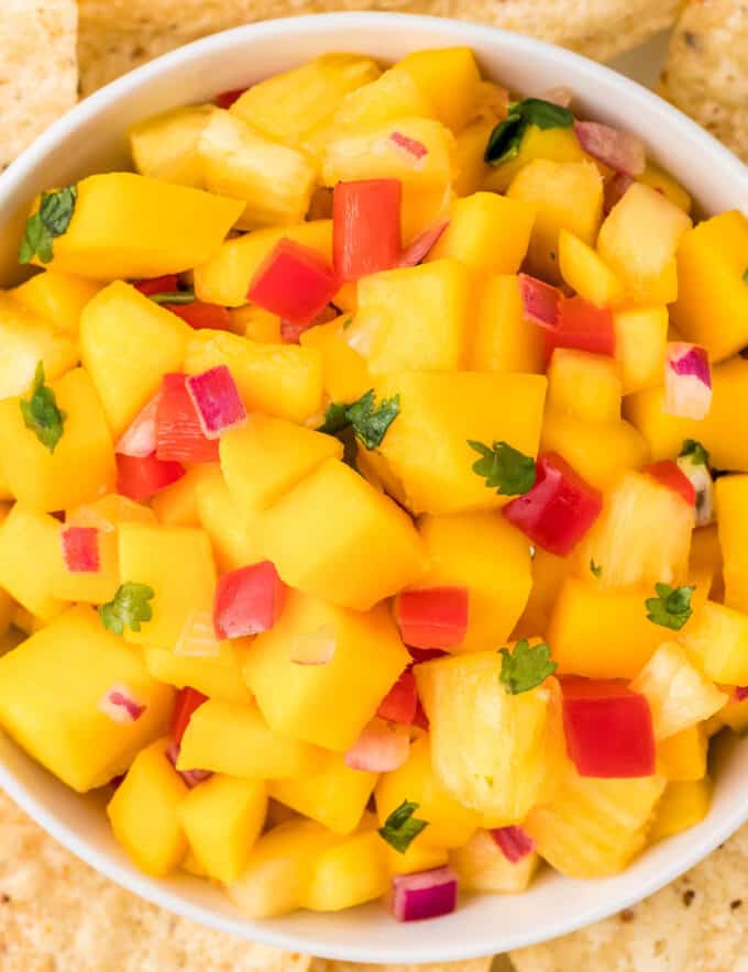 This fresh salsa is made with juicy ripe mangos, fresh pineapple, crunchy bell peppers, spicy fresno pepper, red onion and more! Mango salsa is the perfect accompaniment to your seafood, chicken, or pork tacos!