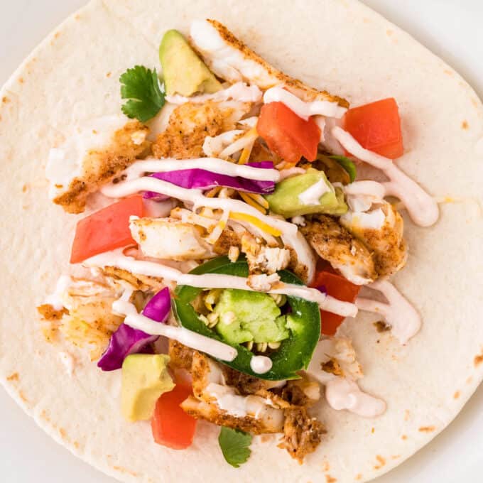 overhead photo of a fish taco laid flat on a flour tortilla